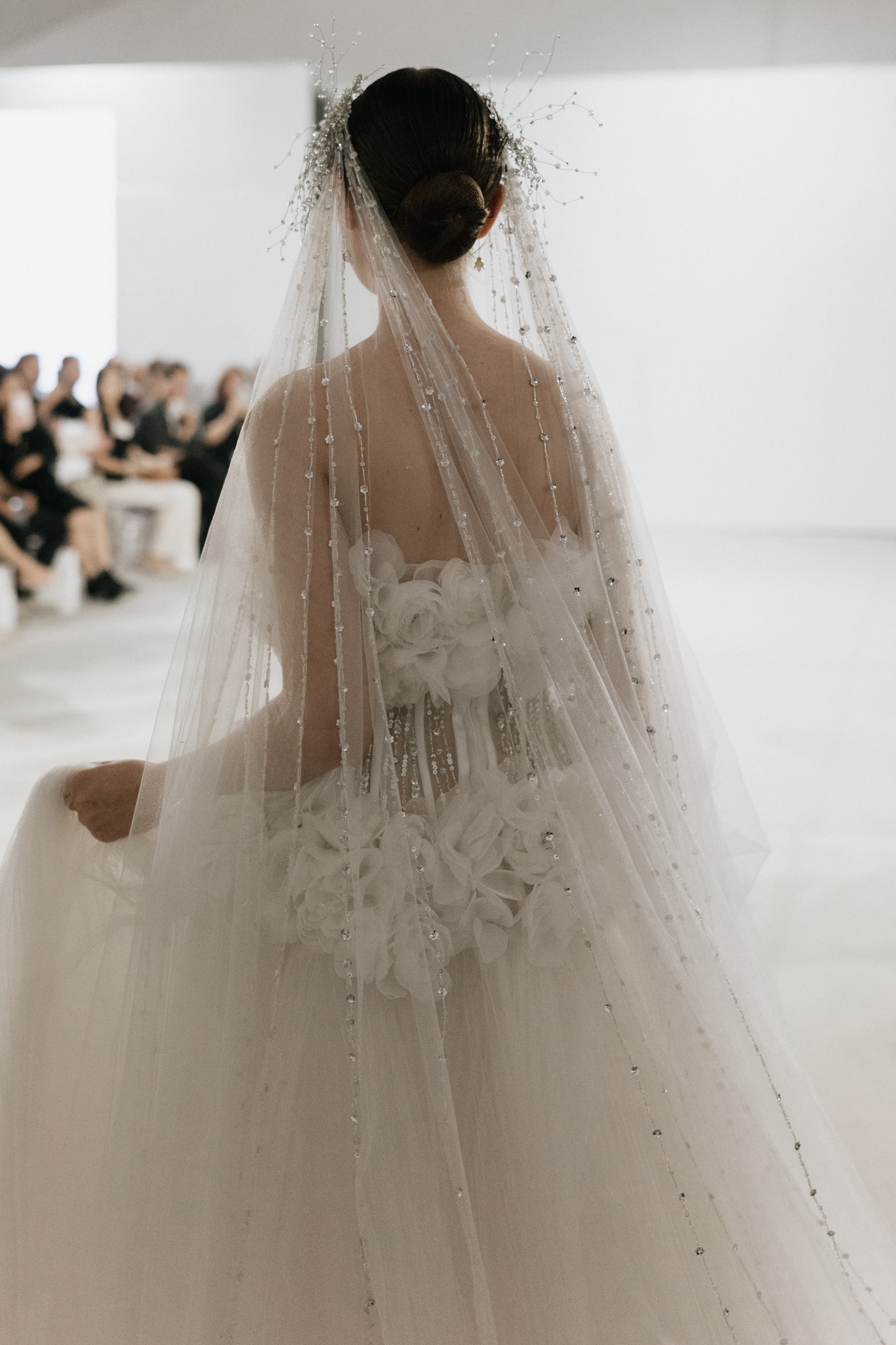 Bride wearing a veil and a custom gown by Abigail Melvira